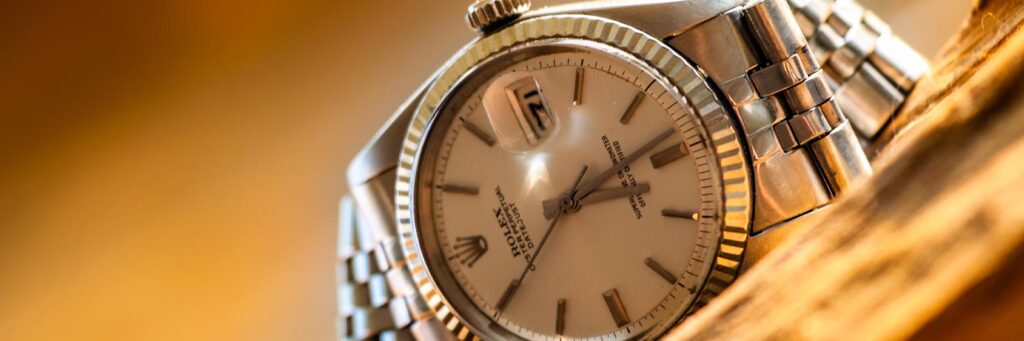 silver rolex watch laying on its side to sell your rolex