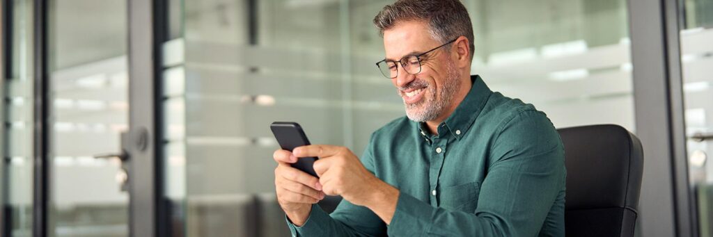 business man on his cell phone setting up watch escrow services for watch buyers