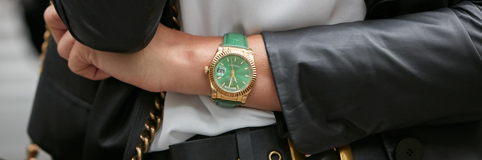 business woman wearing a green dial womens pre owned rolex watch
