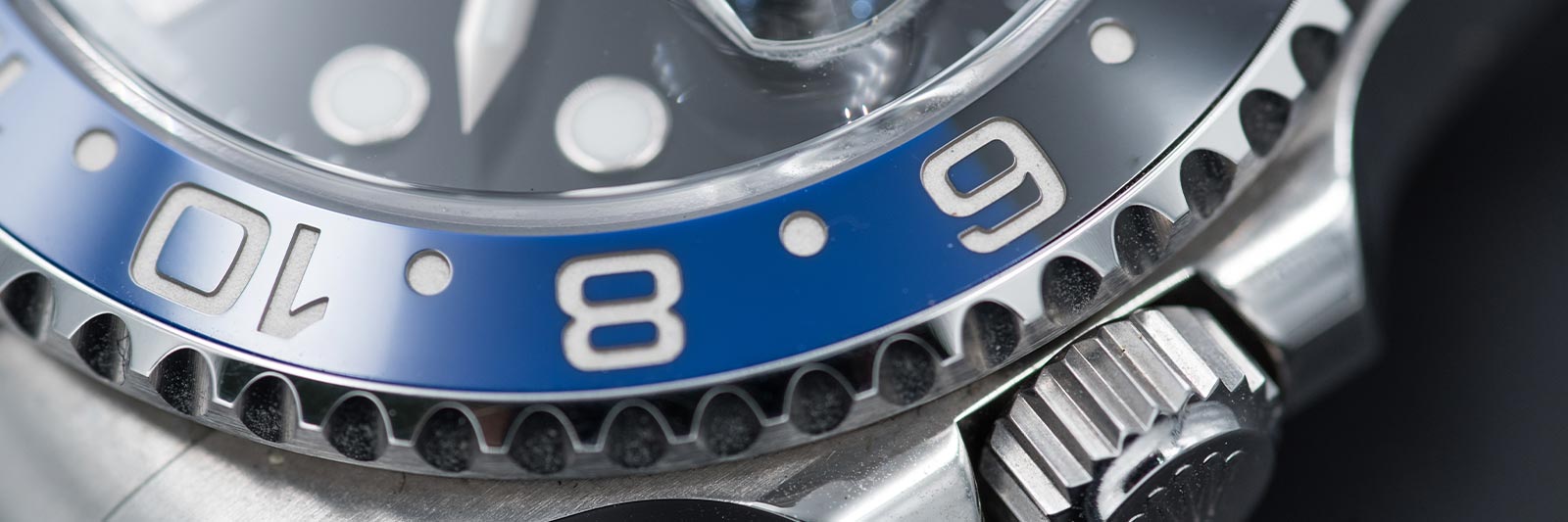 up close view of a freshly polished rolex with a blue dial