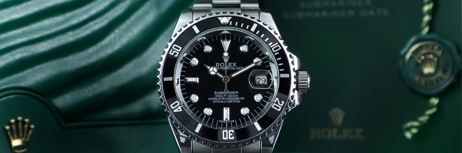 stainless steel Rolex watch with iconic green box in the background during a Rolex watch appraisal