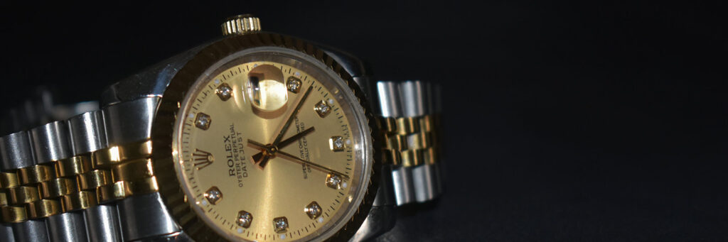 Vintage two tone Rolex on a dark background
