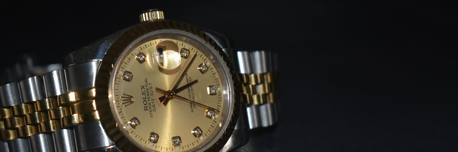 Vintage two tone Rolex on a dark background