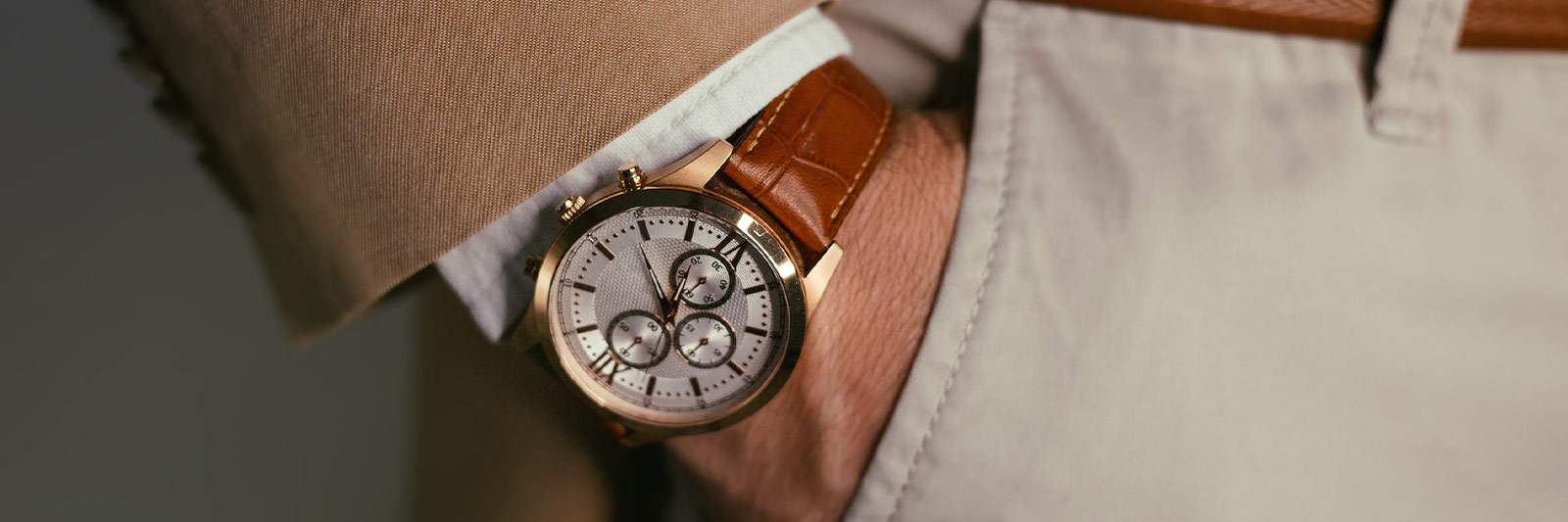 man wearing a vintage watch with brown leather strap.